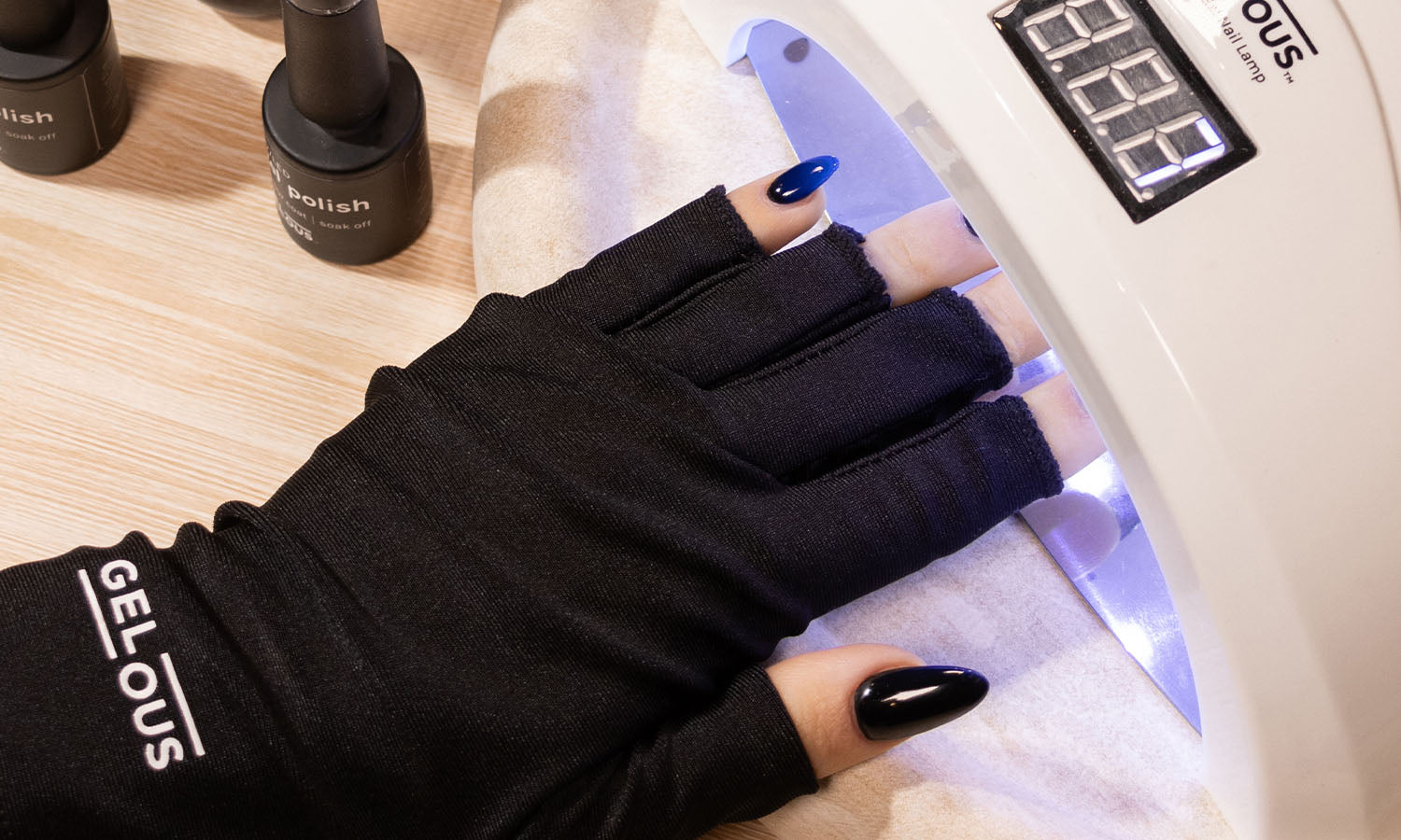 Person wearing a Gelous Anti-UV Glove, applying Gel Nail Polish in front of a UV/LED Gel Nail Lamp - photographed in New Zealand