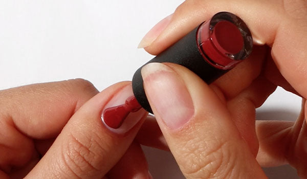 Applying red Gel Nail Polish at home - photographed in New Zealand