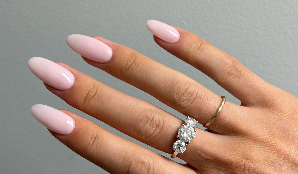 Hand with Angelic Gel Nail Polish and Long Almond Nail Tips on - Applied with Clear Rubber Base Coat - photographed in New Zealand